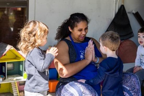 Student working with two children