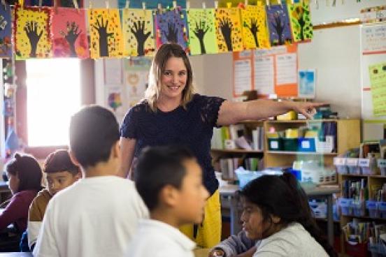 Teacher in classroom talking to students
