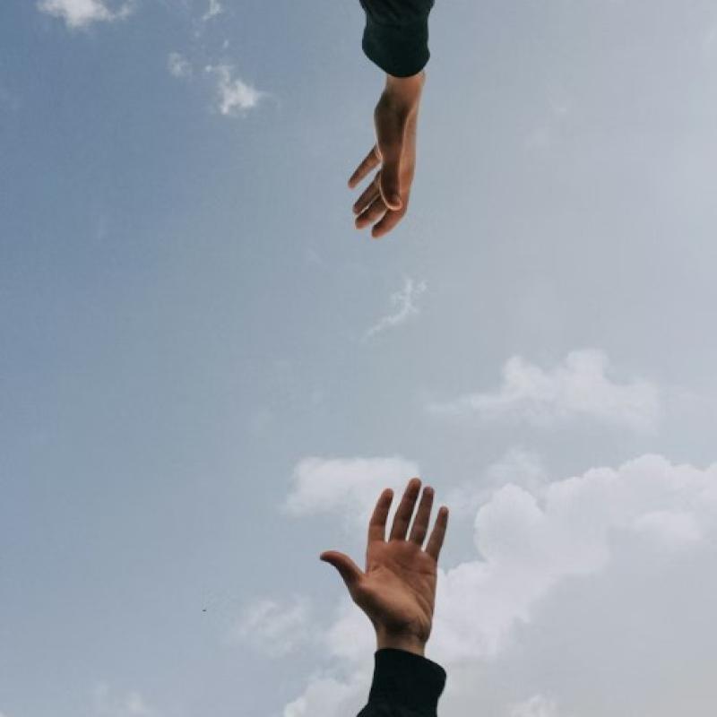 hands reaching for each other